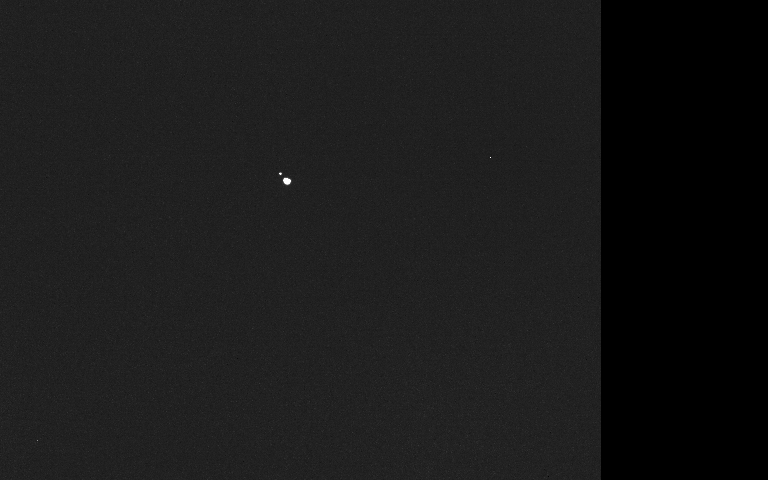 Hera camera image showing Didymos and the smaller Dimorphos as two separate bright points.
