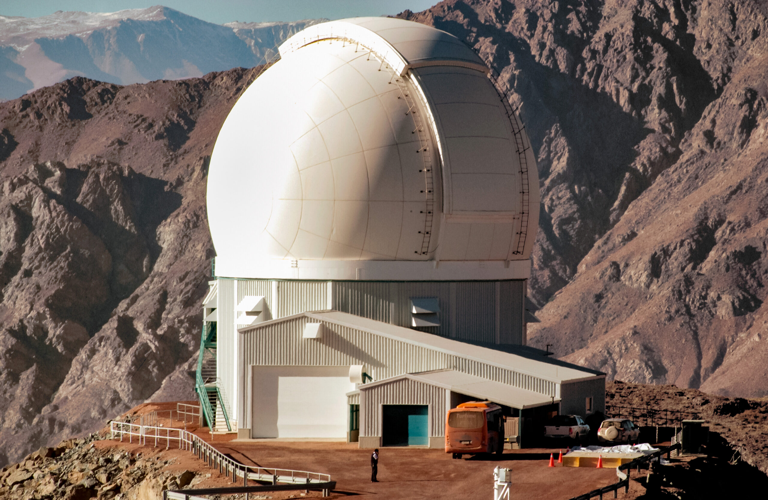 The white dome of the SOAR Telescope stands among rocky mountain ridges at Cerro Pachón in Chile.