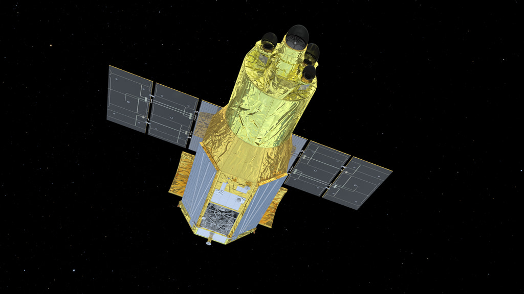 Artist’s concept of the gold-wrapped XRISM spacecraft with two dark solar-panel wings against space.